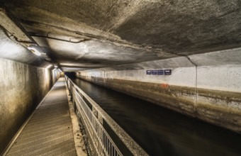 Anderlecht, Brussels, Belgium, 07 16 2019- The covered river La Senne, with a metal walking path at