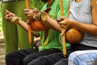 Musicians playing Afro Brazilian percussion musical instruments called berimbau during a capoeira