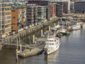 Harbour area with modern designed buildings along a canal. Boats and railings at the harbour,