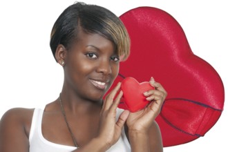 A beautiful young African American black woman holding a Valentines Day heart