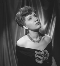 In the 1940s. Actress Barbro Kollberg pictured in studio wearing a shoulderless dress with a