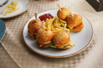 Mini burgers and fried potatoes on the table at party food. Finger food on catering