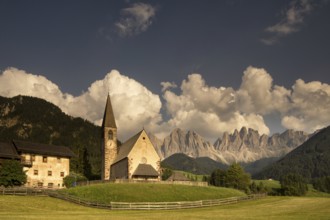 The Sankt Magdalena church in front of the Geislergruppe mountain tops in the Italian Dolomites