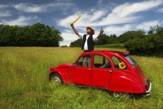 Typical French man with bread wine and his car