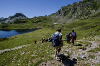 Hiker on Lac Gentau, Ayous lakes tour, Pyrenees National Park, Pyrenees Atlantiques, France, Europe