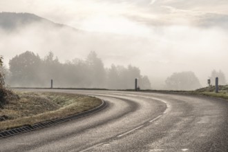Bend on a wet road in the mountain. Vosges, France, Europe