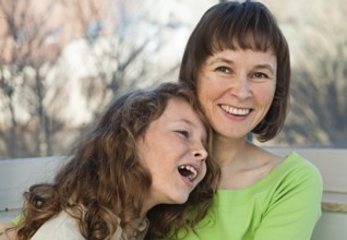 Happy smiling mother together with her teenager daughter at home, Belgium, Europe