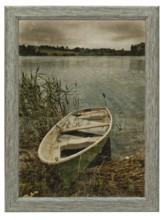Decorative old photo of boat at lake in wooden frame
