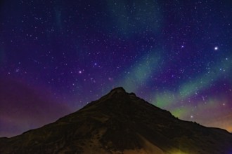 Of Iceland Aurora and mountain silhouette. Shooting Location: Iceland, Reykjavik