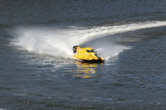 PESO DA REGUA, PORTUGAL - SEPTEMBER 15, 2024: Yellow Powerboat Makes Sharp Turn with Splashes of