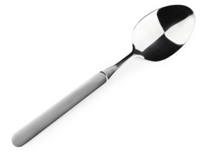 Single soup spoon over the white background