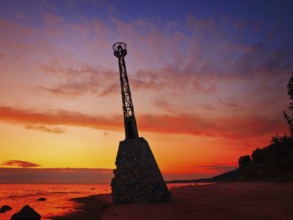Beacon on the seashore against the dusk