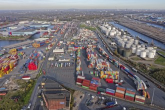 Commercial port with container terminal and oil tanks at the Rhine river in North Rhine-Westphalia,
