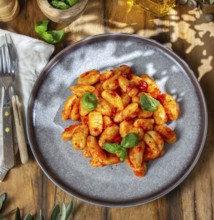 Food, Italian Gnocchi with tomato sauce and basil on wooden background