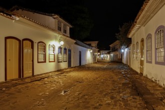 Atmospheric night view of illuminated street and buildings in historical center of Paraty, Brazil,