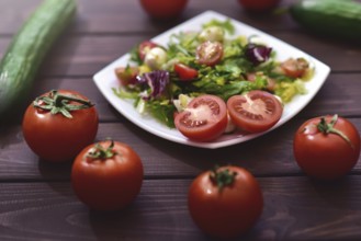 Healthy dietary meals. Mix salad of vegetables on a wooden background. Hello spring. Healthy body