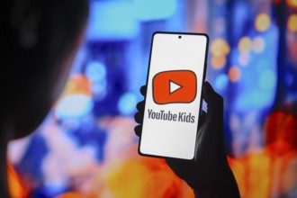 In this photo illustration, the YouTube Kids logo is displayed on a smartphone screen