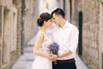 Sibenik, Croatia - 05.06.17: Groom leaned his forehead against the bride's forehead with a lavender