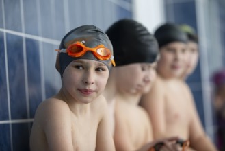 Belarus, the city of Gomel, March 10, 2021. School pool. A boy in a swimming cap looks at the