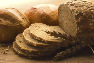 Close-up of a freshly baked loaf of bread with a wheat head