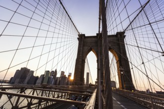 Brooklyn Bridge sunset with Manhattan skyline of New York City USA