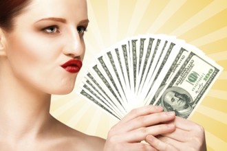 Creative portrait of a naked girl with beautiful face and body holding hand fan made of 100 dollar
