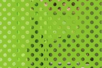 Closeup of green honeycombed fence with blurred background