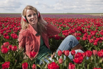 Dutch girl with long blond hair is listening to music