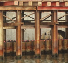 Bridge construction detail with massive steel girders anchored in the ground