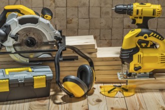 Construction carpentry electric hand tools on wooden background