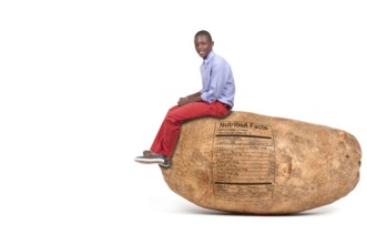 Handsome young black teenager sitting on a potato