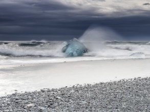 Diamond Beach, iceberg in the surf, near Jökulsarlon glacier lagoon, Vatnajökull National Park,