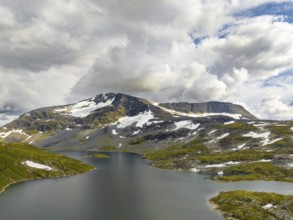 Typical fjord landscape in norway with high snow covered mountains and deep lakes