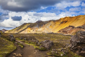 Travel to Iceland in July, volcanic summer tundra. Multi-colored rhyolite mountains - orange,