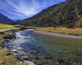 Austrian Alps. Starting famous Krimml waterfalls. Crystal clear water sparkles in the midday sun.