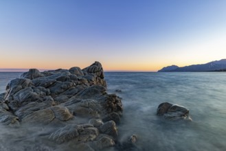 Rocks in the sea on the beach of Torre di Bari at sunset, long exposure, Torre di Bari, Bari Sardo,