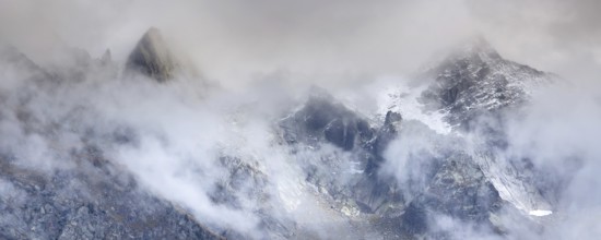Fantastic snow mountains landscape banner background with snow peaks and clouds, French Alps