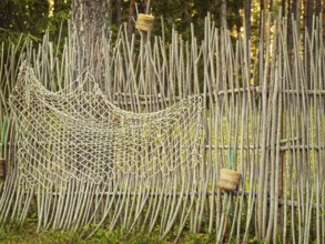 Fence with fishing net in the forest