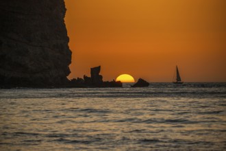 Sunrise during a sandstorm, Calima. The haze-covered horizon turns orange as the sun rises as a