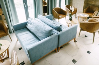 Bellagio, Italy - 07 june 2020: A large hall with blue sofas and pillows, with empty tables and