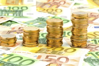 Stack of coins, rising curve, symbolic photo for rising profits and also rising costs Austria