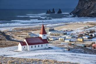 Icelandic village of Vik, Southeast Iceland with the VIk i Myrdal church at the top of the hill