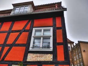 Historic half-timbered house with red and black beams and white windows, stralsund, mecklenburg,