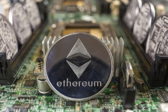 Ethereum coin close-up on a computer circuit motherboard as a blockchain technology payment network