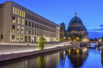 The modern rear of the City Palace, the cathedral and the Spree in Berlin by night