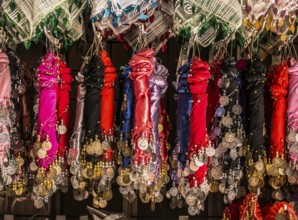 Plenty of fake gold coins are on the scarf edges