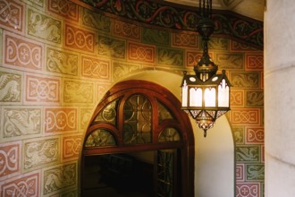 Antique wall lamp on a spiral staircase in Neuschwanstein Castle.