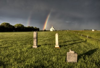 Old Country Church in Saskatchewan Canada with storm clouds rainbow