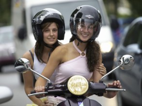 Two woman riding a scooter, Barcelona, Spaina