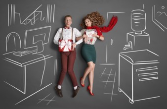 Happy valentines love story concept of an office romance. Young couple at work smiling at each
